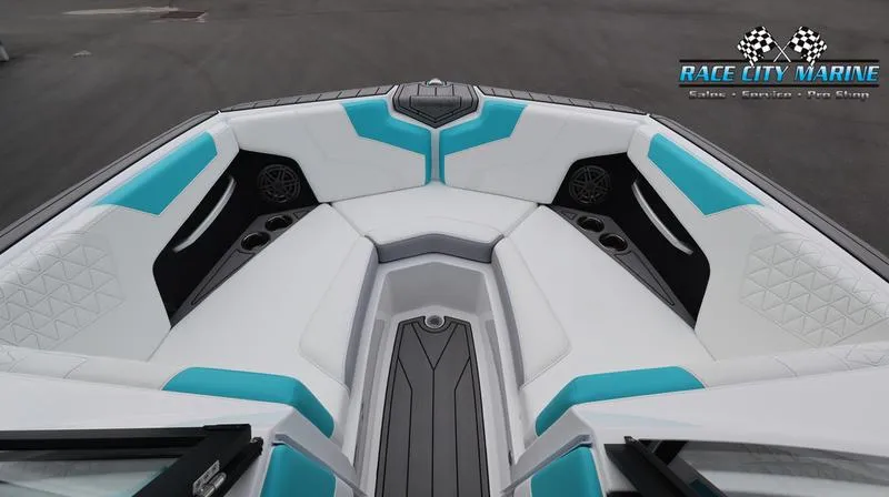 Slide: The Image of 2024 Nautique GS22 boat interior with white and turquoise seating. - 47