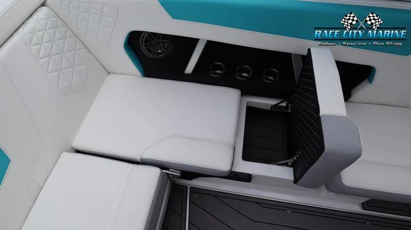 Slide: The Image of 2024 Nautique GS22 boat interior with white and teal seating. - 48