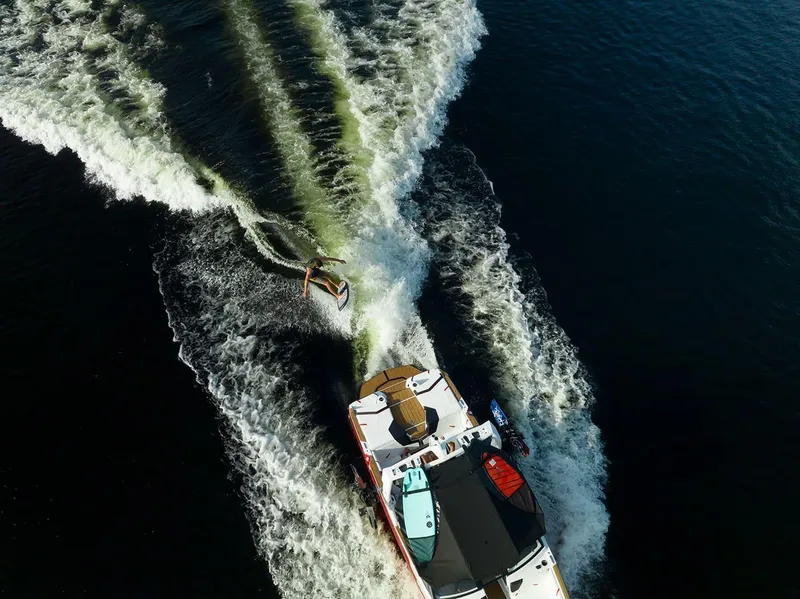 Slide: The Image of Aerial view of a 2024 Nautique GS22 boat towing a wakeboarder. - 5