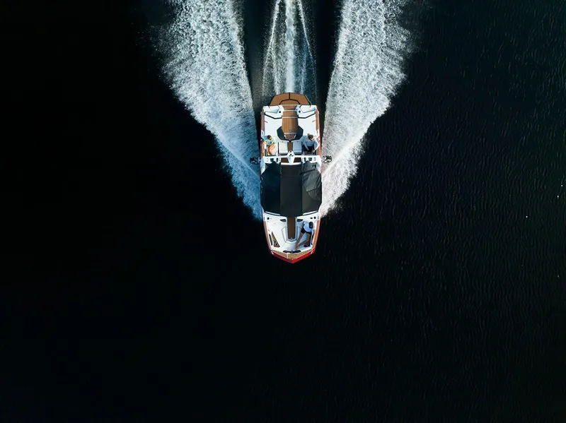 Slide: The Image of Aerial view of 2024 Nautique GS22 boat cruising on water. - 9
