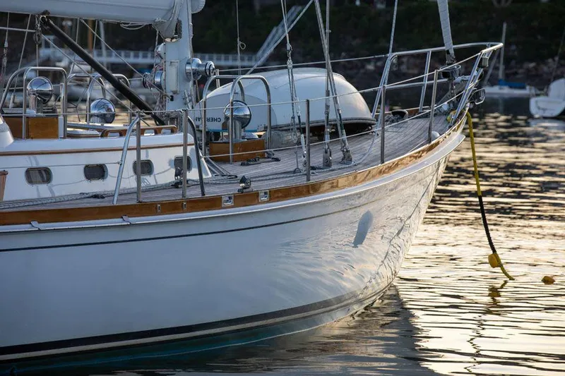 Slide: The Image of Hinckley OceanCruising 52 yacht, 1997 model, docked on calm water at sunset. - 12