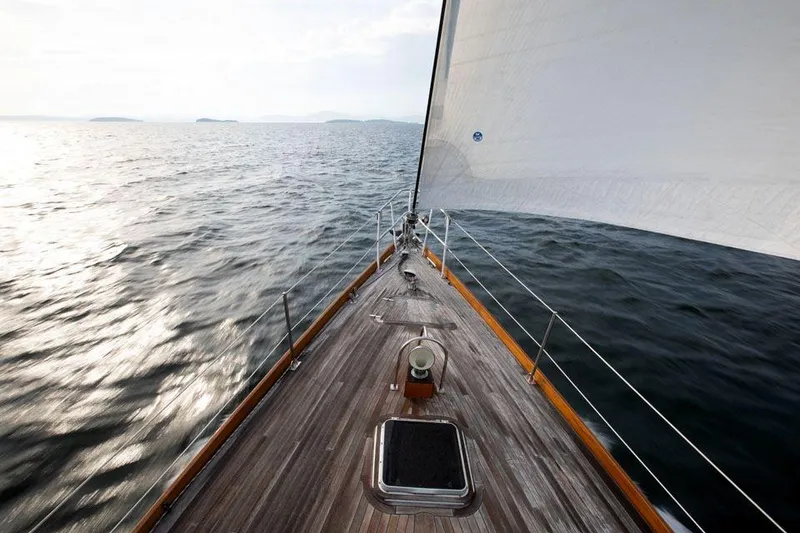 Slide: The Image of Hinckley OceanCruising 52 sailboat on open sea, 1997 model, wooden deck, sailing forward. - 17
