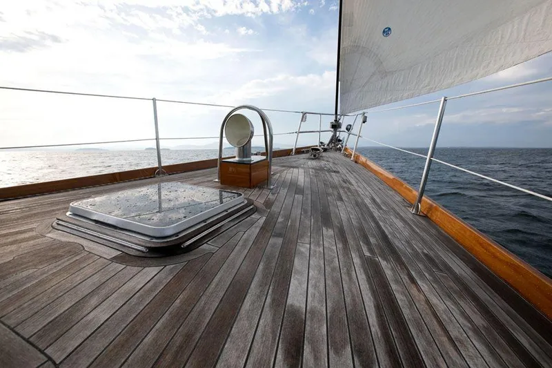 Slide: The Image of Hinckley OceanCruising 52 yacht deck, 1997 model, sailing on open sea under cloudy sky. - 18