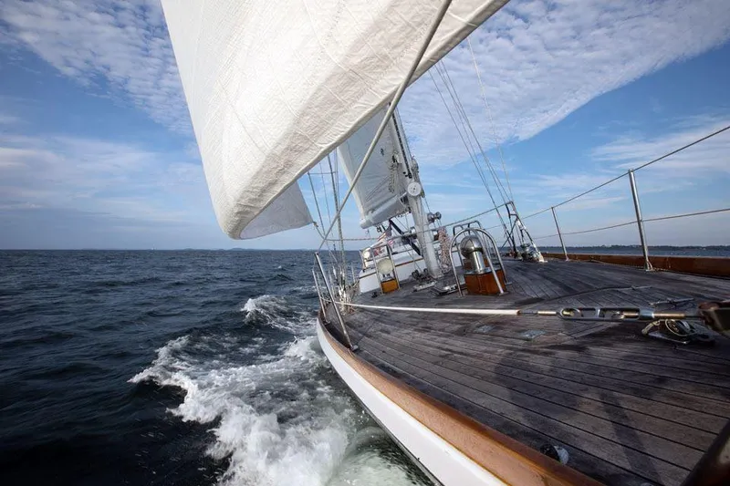 Slide: The Image of Hinckley OceanCruising 52 sailboat from 1997 navigating open sea under clear skies. - 21