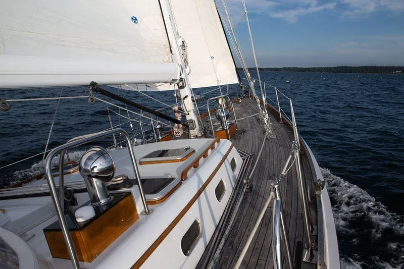 Slide: The Image of Hinckley OceanCruising 52 sailboat from 1997 navigating open waters under clear skies. - 25