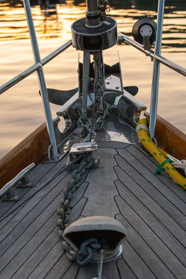 Slide: The Image of Bow of 1997 Hinckley OceanCruising 52 yacht with anchor chain at sunset. - 27