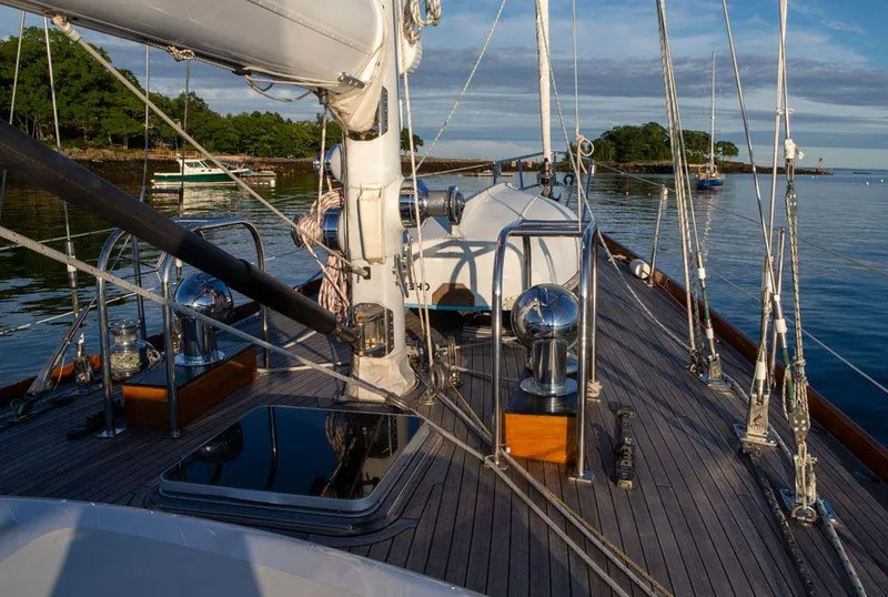 Slide: The Image of Hinckley OceanCruising 52 sailboat deck, 1997 model, with rigging and serene waterfront view. - 28