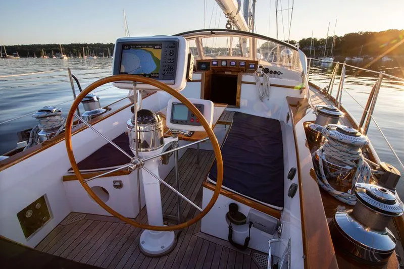 Slide: The Image of Cockpit of 1997 Hinckley OceanCruising 52 yacht with navigation equipment and wooden steering wheel. - 32