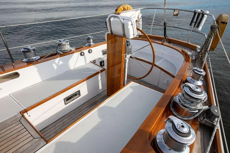 Slide: The Image of Hinckley OceanCruising 52 yacht deck, 1997 model, featuring polished wood and steering wheel. - 35