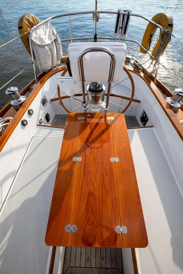 Slide: The Image of Hinckley OceanCruising 52 cockpit, 1997 model, featuring wooden table and steering wheel. - 36