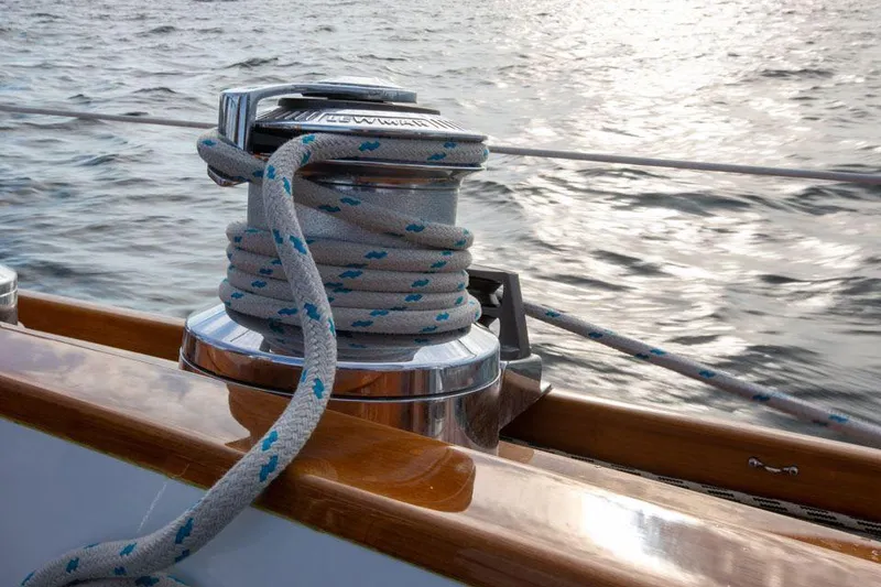 Slide: The Image of Hinckley OceanCruising 52 sailboat winch with rope, 1997 model, on open water. - 47