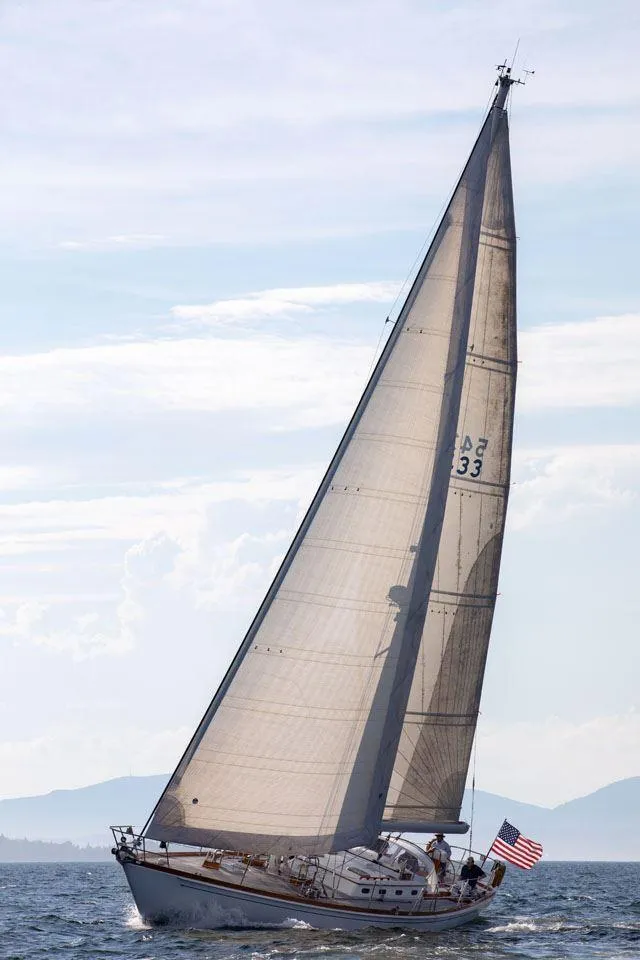 Slide: The Image of Sailing yacht Hinckley OceanCruising 52, 1997 model, gliding on open sea with American flag. - 5