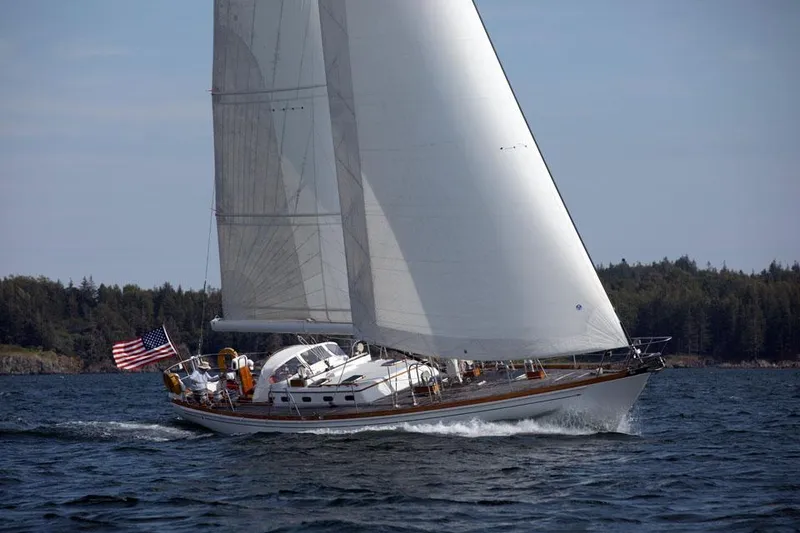 Slide: The Image of Sailing yacht Hinckley OceanCruising 52, 1997 model, gliding on open water with American flag. - 9