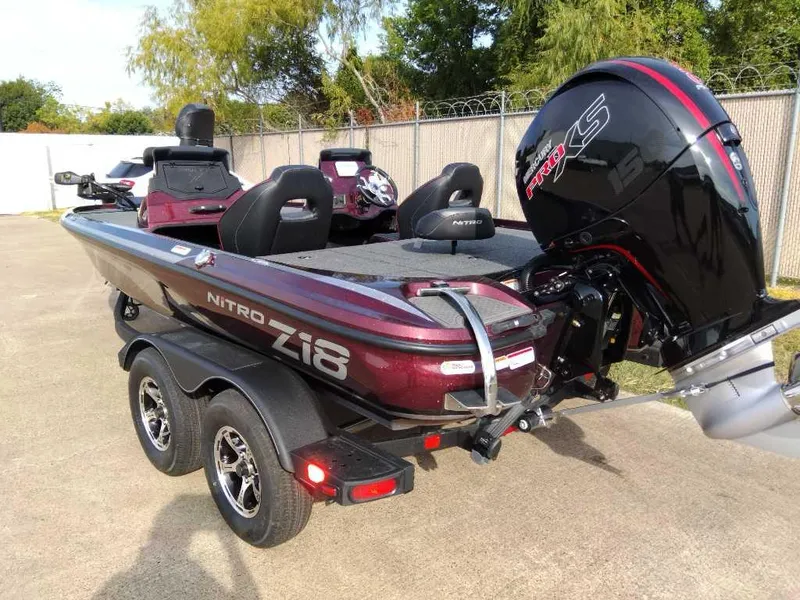 Slide: The Image of 2024 Nitro Z18 boat with dual axle trailer and powerful outboard motor. - 5