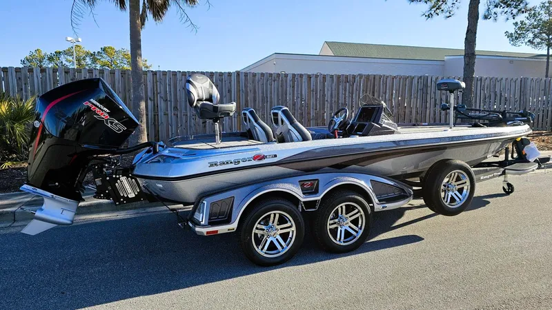 Slide: The Image of 2024 Ranger Z521R Ranger Cup Equipped boat on trailer, parked outdoors. - 0