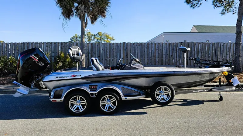 Slide: The Image of 2024 Ranger Z521R Ranger Cup Equipped boat on a trailer, parked outdoors. - 1