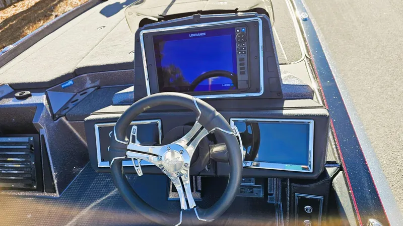 Slide: The Image of 2024 Ranger Z521R boat dashboard with steering wheel and electronic display. - 7