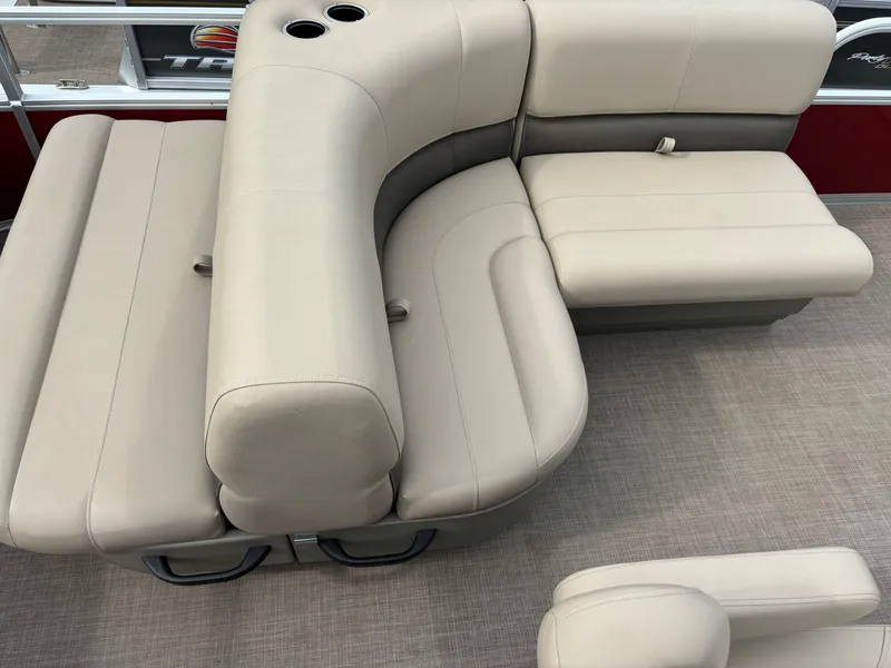 Slide: The Image of 2024 Sun Tracker Party Barge 18 DLX beige seating area with cup holders. - 9