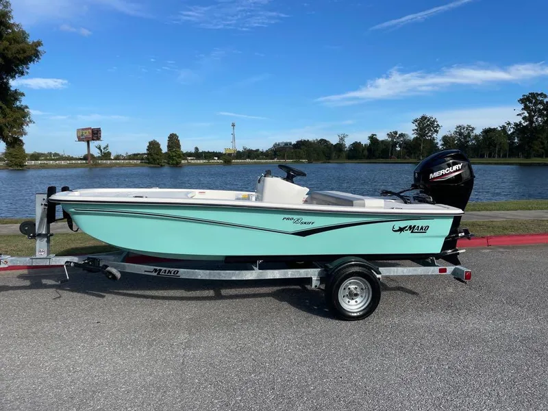The Image of 2024 Mako Pro Skiff 13 CC boat on trailer by a lake. - 0