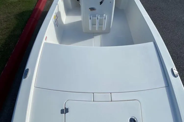Slide: The Image of 2024 Mako Pro Skiff 13 CC boat interior, white deck and storage compartments. - 2