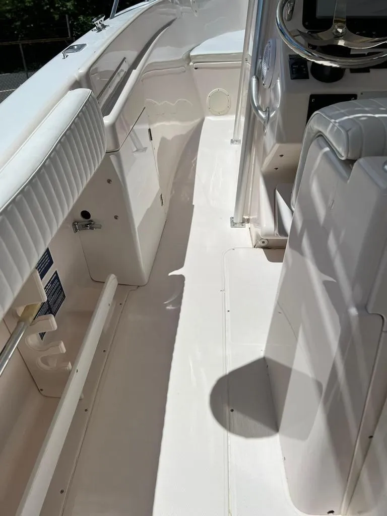 Slide: The Image of 1995 Grady-White Chase 263 boat interior, featuring white seating and sleek design. - 10