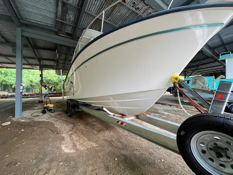 Slide: The Image of 1995 Grady-White Chase 263 boat on trailer under metal roof, side view. - 11