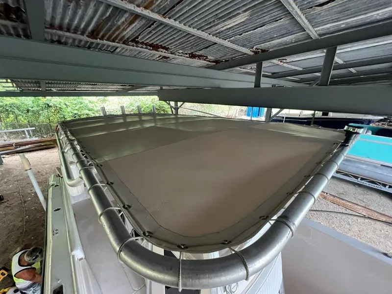 Slide: The Image of 1995 Grady-White Chase 263 boat under metal roof, view of top deck and railing. - 3