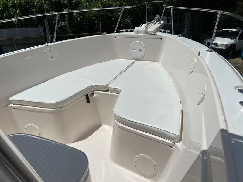 Slide: The Image of 1995 Grady-White Chase 263 boat interior with white cushioned seating and railings. - 6