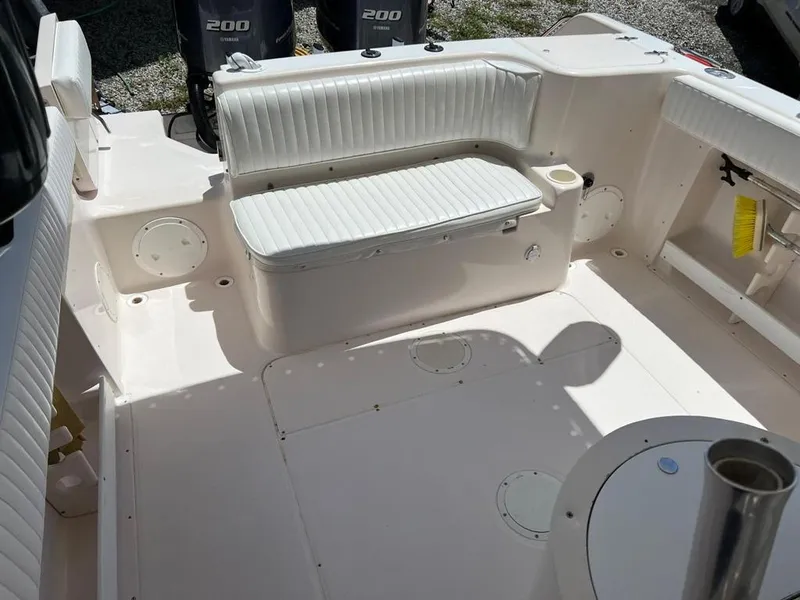Slide: The Image of 1995 Grady-White Chase 263 boat interior with seating and twin 200 engines. - 7