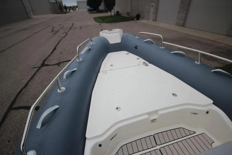 Slide: The Image of 2024 Zodiac Medline 7.5 NEO boat, white deck, gray inflatable sides, docked outdoors. - 28