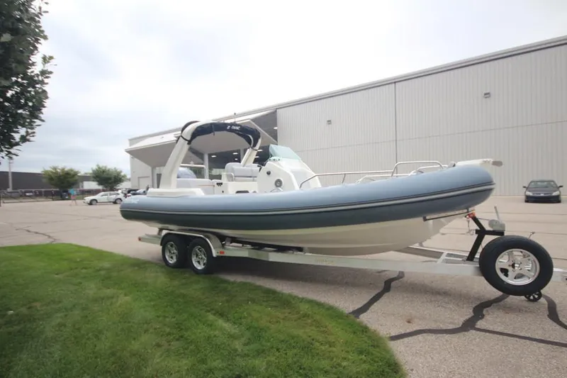 Slide: The Image of 2024 Zodiac Medline 7.5 NEO 300hp boat on trailer outside warehouse. - 3