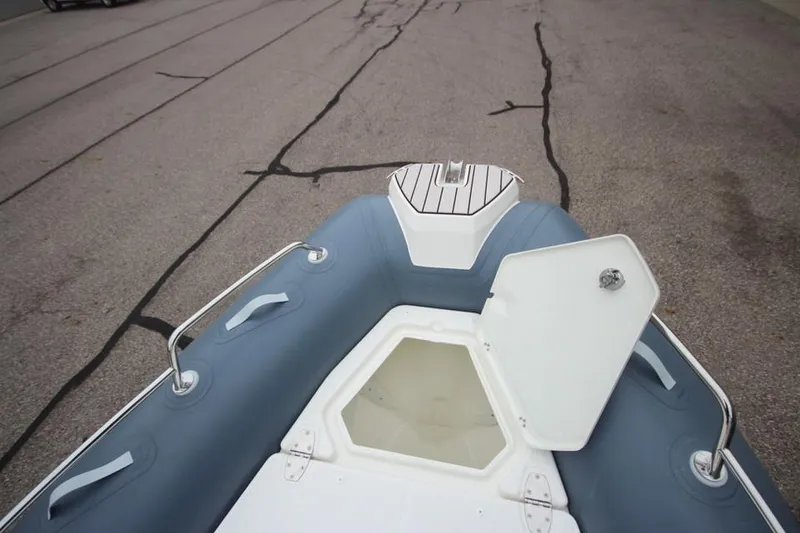 Slide: The Image of 2024 Zodiac Medline 7.5 NEO boat with open storage compartment on deck. - 31