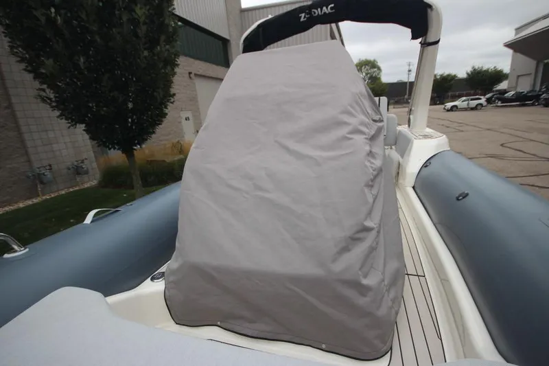 Slide: The Image of 2024 Zodiac Medline 7.5 NEO boat with covered console, docked outdoors. - 34