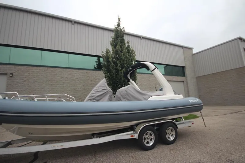 Slide: The Image of 2024 Zodiac Medline 7.5 NEO 300hp boat on trailer outside industrial building. - 36