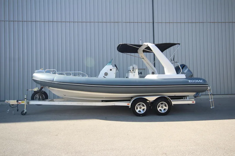 Slide: The Image of 2024 Zodiac Medline 7.5 NEO boat on trailer, side view, gray and white design. - 37
