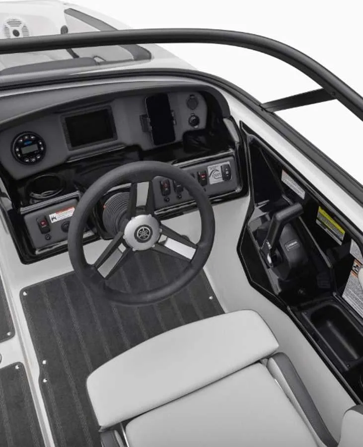 Slide: The Image of 2023 Yamaha Boats SX195 cockpit with steering wheel and control panel. - 2