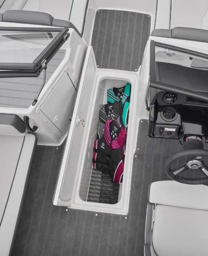Slide: The Image of 2023 Yamaha Boats SX195 interior storage compartment with life jackets. - 5