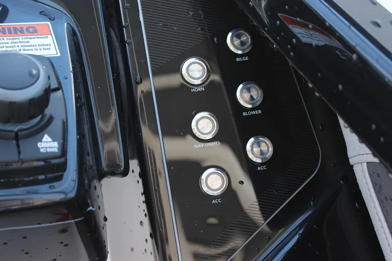 Slide: The Image of Control panel of 2023 Yamaha Boats 252SE with various switches. - 10