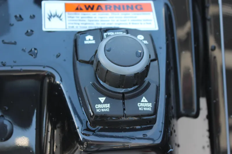Slide: The Image of Close-up of 2023 Yamaha Boats 252SE control panel with cruise and no wake buttons. - 11
