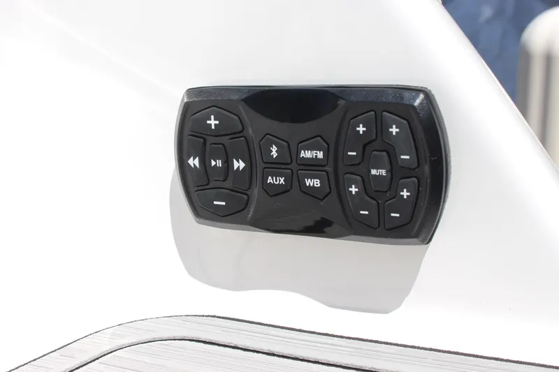 Slide: The Image of Control panel of a 2023 Yamaha Boats 252SE, featuring audio and auxiliary buttons. - 17