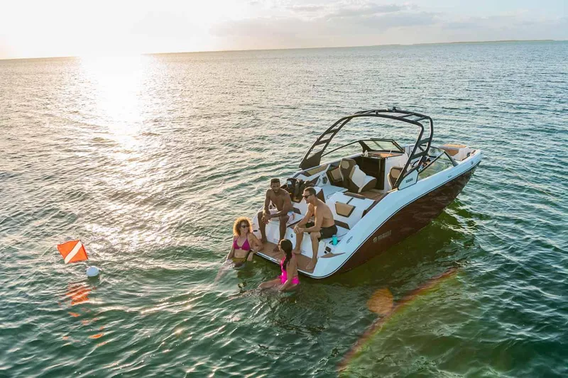 Slide: The Image of 2023 Yamaha Boats 222S with people enjoying water activities at sunset. - 3