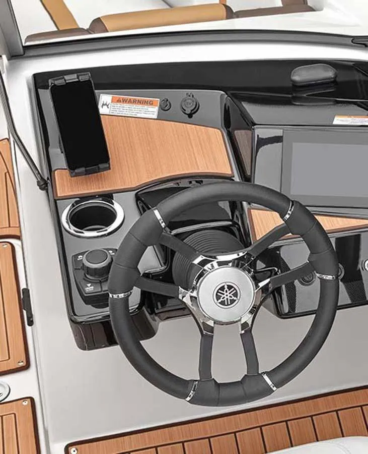 Slide: The Image of Steering console of 2023 Yamaha Boats 222S with modern controls and wood accents. - 6