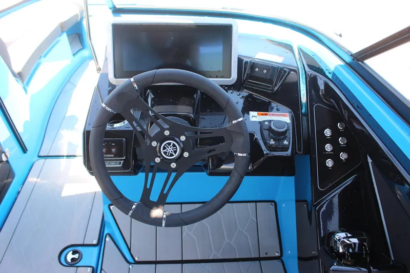 Slide: The Image of 2023 Yamaha Boats 255XE cockpit with steering wheel and touchscreen display. - 10