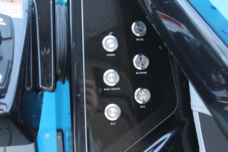Slide: The Image of Control panel of a 2023 Yamaha Boats 255XE with various switches. - 11