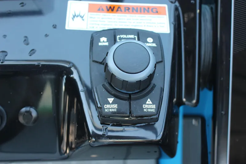Slide: The Image of Control panel of 2023 Yamaha Boats 255XE with cruise and volume buttons. - 12