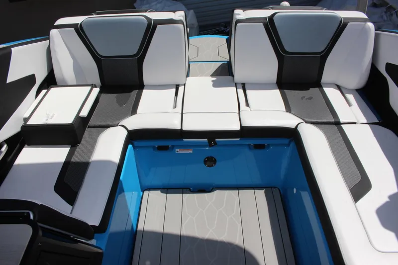 Slide: The Image of 2023 Yamaha Boats 255XE interior seating area with modern design and blue accents. - 14