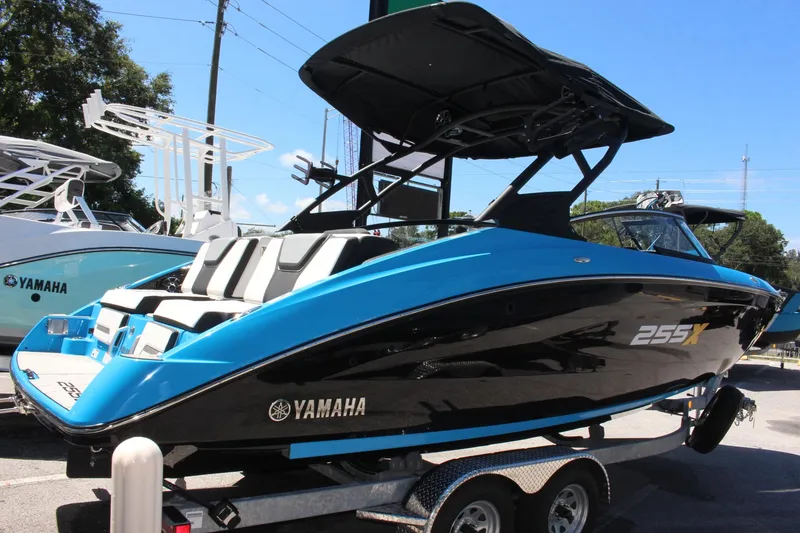 Slide: The Image of 2023 Yamaha Boats 255XE in blue and black on a trailer. - 3