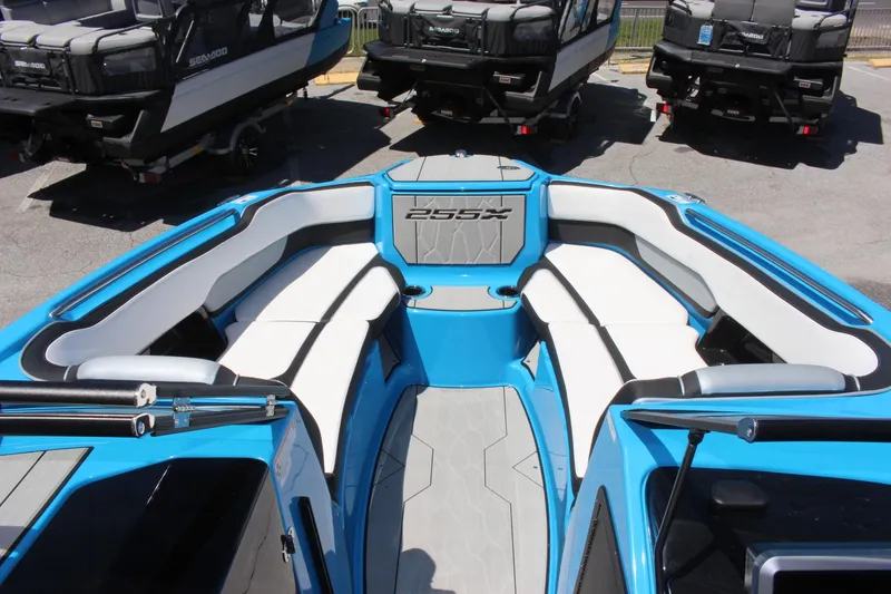 Slide: The Image of 2023 Yamaha Boats 255XE interior with white and blue seating. - 5