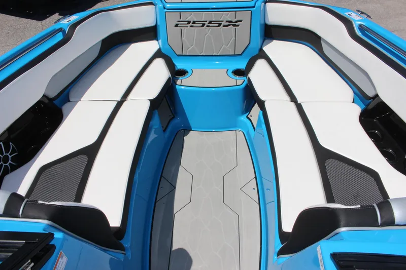Slide: The Image of 2023 Yamaha Boats 255XE interior seating area with blue and white upholstery. - 6