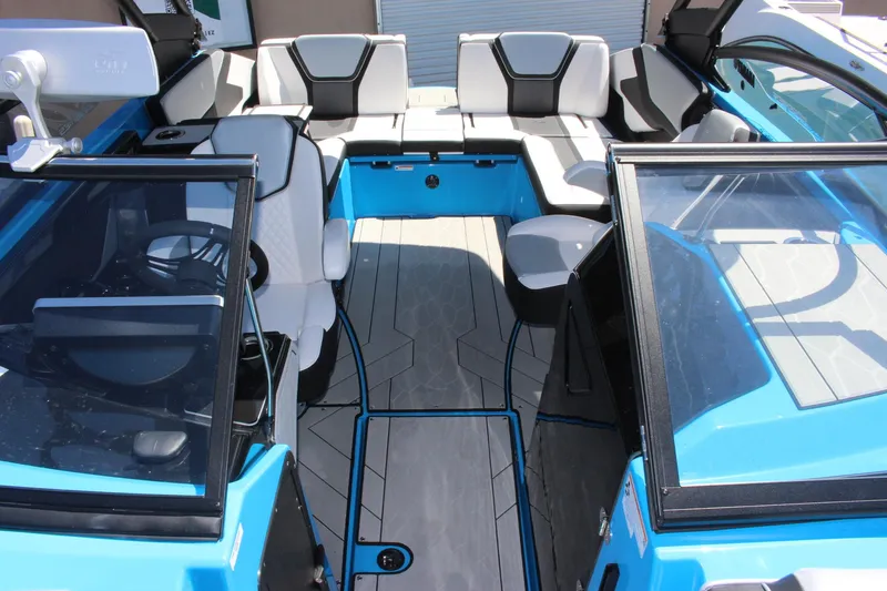 Slide: The Image of 2023 Yamaha Boats 255XE interior, blue and white seating, open deck layout. - 7